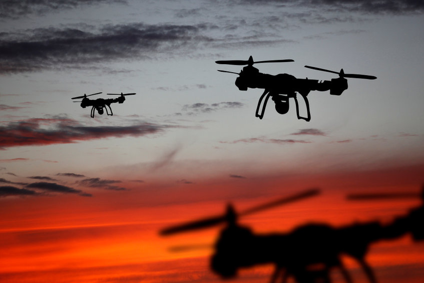 innovation concept. silhouette of drone flying on sunset. heavy lift drone photographing